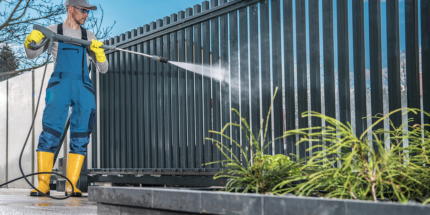 Caucasian Men Washing His Residential Driveway Gate
