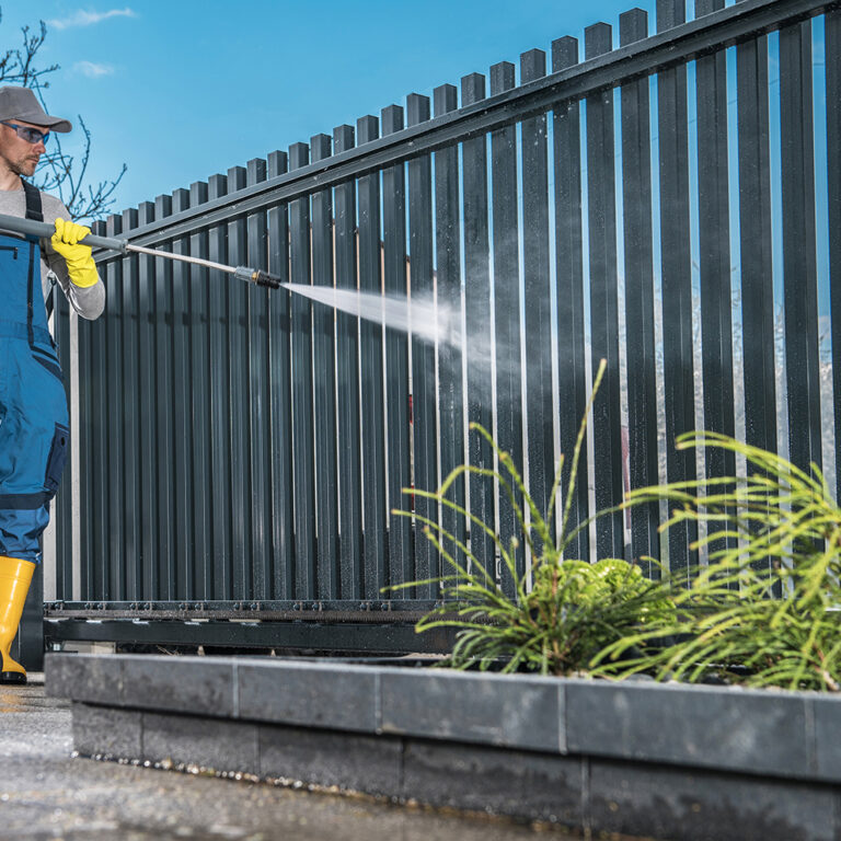 Caucasian Men Washing His Residential Driveway Gate